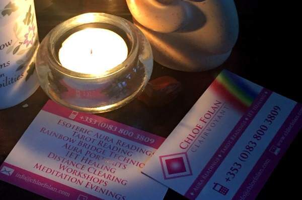 Business cards adjacent to a candle