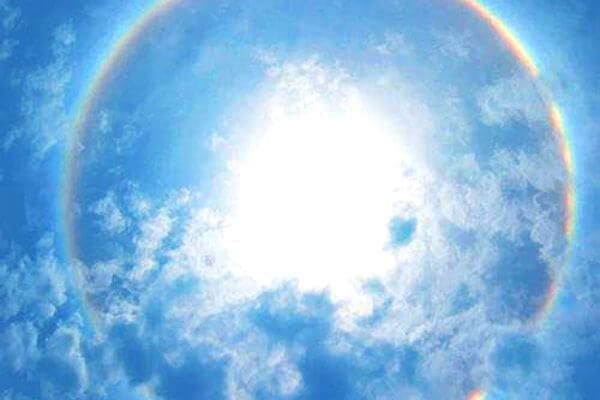 Sun over the horizon of earth and rainbow effect